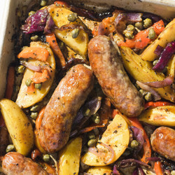 Roast Italian Sausages Over Potatoes And Peppers