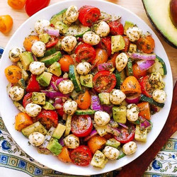 Tomato Cucumber Avocado Salad With Mozzarella And Basil Pesto