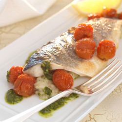 Grilled Fillets Of Sea Bass With Herb Risotto, Roasted Cherry Tomatoes And Pesto