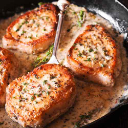 Boneless Pork Chops In Creamy Garlic And Herb Wine Sauce