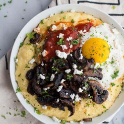 Caramelized Mushroom And Marinara Fontina Polenta With Goat Cheese + Fried Eggs.