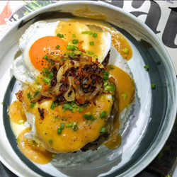 Classic loco moco with grilled onions and sunnyside up egg