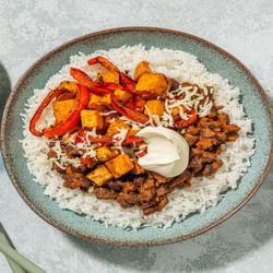 Sweet Potato And Refried Bean Burrito Bowl With Soured Cream And Cheese
