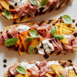 Grilled Flatbreads Topped With Peach, Prosciutto And Burrata
