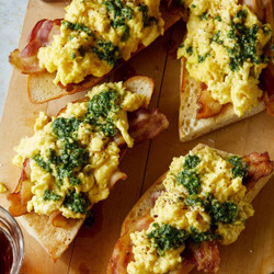 Pesto Topped Soft Scrambled Eggs With Bacon Over Toasted Baguette