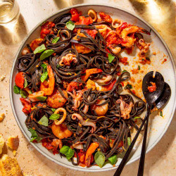 Bobby Flay’s Squid Ink Fettuccine With Shrimp, Squid, And Scallops Tastes Like A Trip To Italy