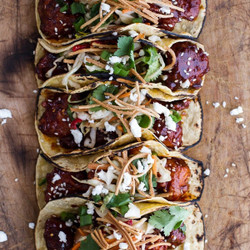 Korean Fried Chicken Tacos With Sweet Slaw, Crunchy Noodles + Queso Fresco.