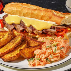 Philly Cheesesteak with pan-fried vegetables, potato wedges &amp; carrot slaw